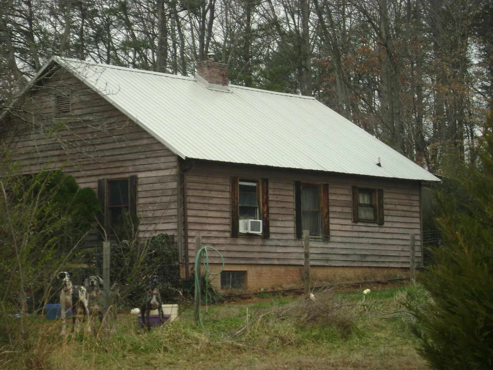 White metal roof on an old wood sided farmhouse, from a Metal Roof Installation job in Brodnax